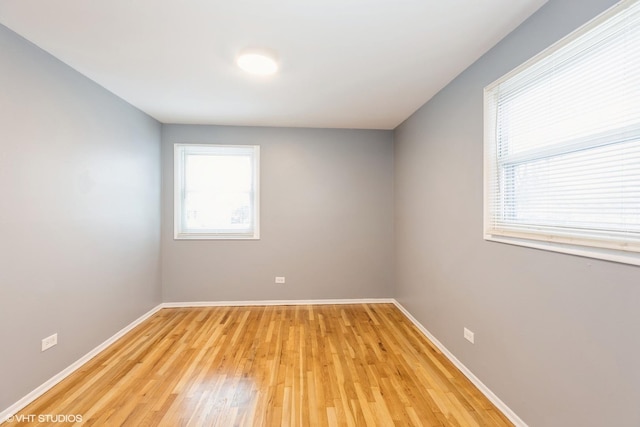 empty room with light hardwood / wood-style flooring