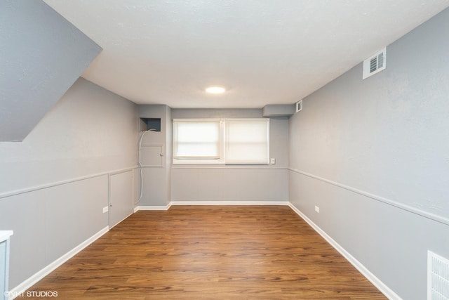 basement with hardwood / wood-style flooring