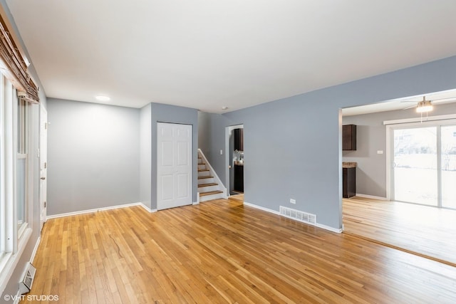 spare room with ceiling fan and light wood-type flooring