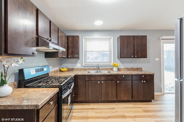 kitchen with sink, stainless steel appliances, dark brown cabinetry, and a healthy amount of sunlight