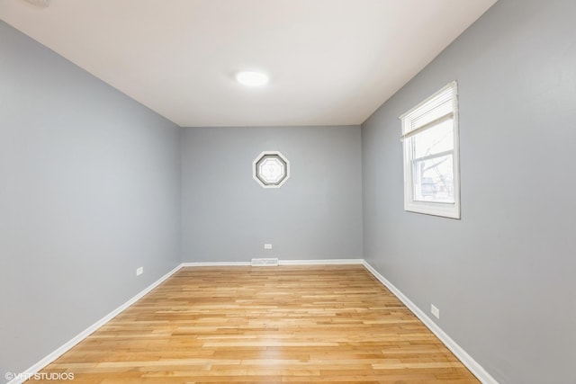 spare room with light hardwood / wood-style flooring