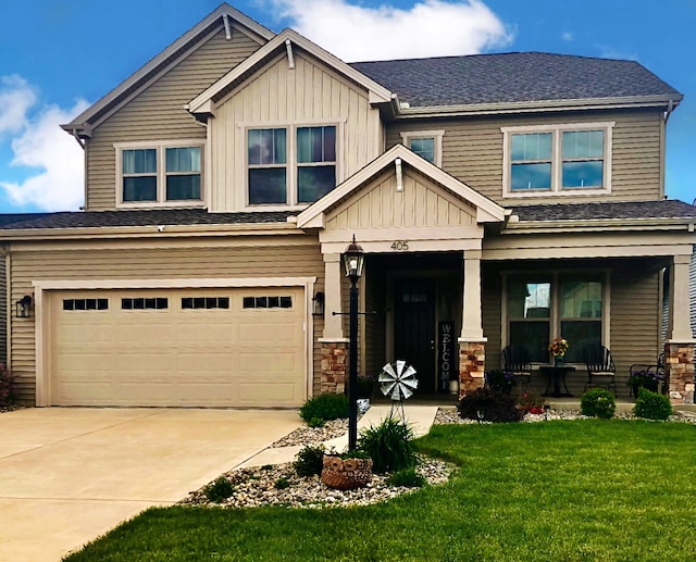 craftsman inspired home featuring a garage, a front yard, and covered porch