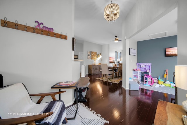 interior space featuring ceiling fan with notable chandelier and wood-type flooring