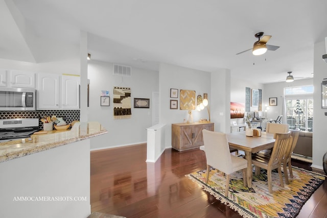 dining area featuring dark wood-type flooring