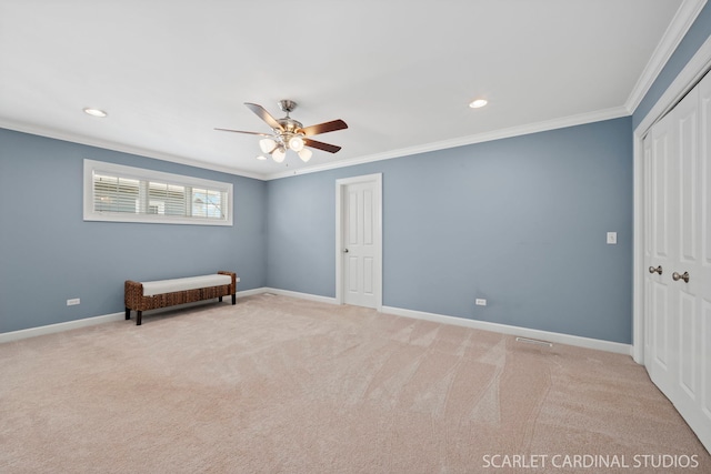 unfurnished bedroom featuring crown molding, light colored carpet, a closet, and ceiling fan