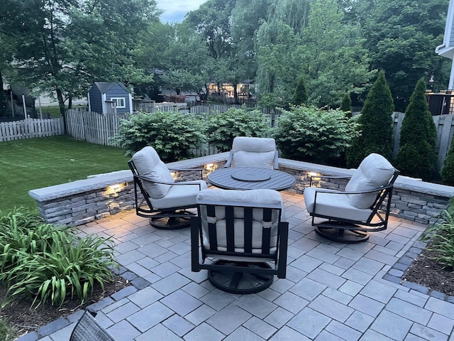 view of patio with a storage shed and an outdoor fire pit