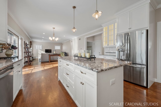 kitchen featuring white cabinetry, light stone counters, dark hardwood / wood-style floors, a kitchen island, and stainless steel appliances