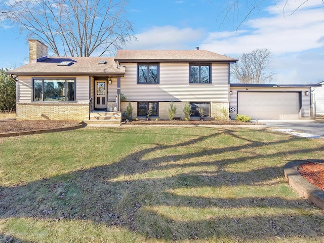 tri-level home featuring a garage and a front yard