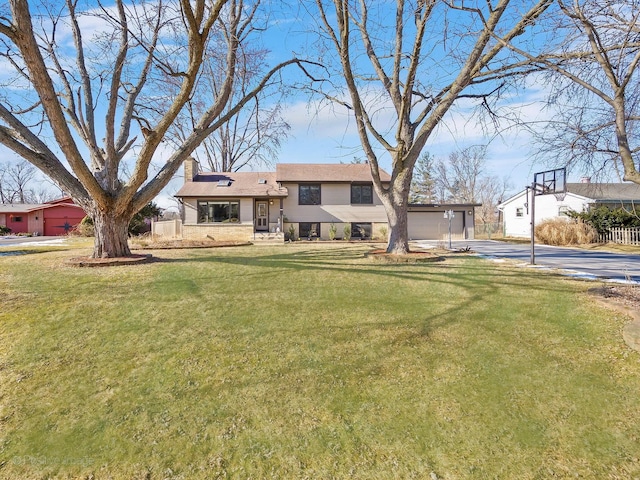 tri-level home with a front yard