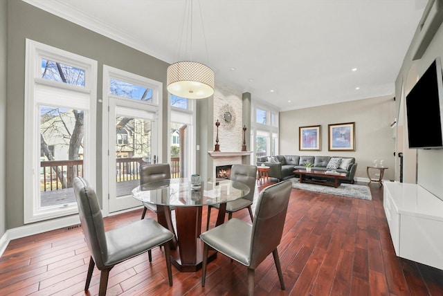 dining area with ornamental molding and dark hardwood / wood-style floors