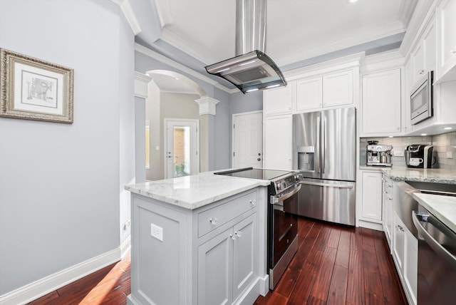 kitchen featuring white cabinetry, light stone counters, stainless steel appliances, and island exhaust hood