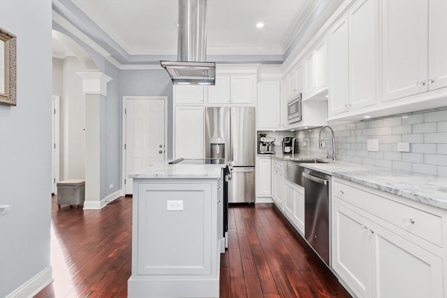 kitchen with sink, light stone counters, a kitchen island, stainless steel appliances, and white cabinets