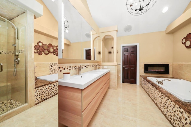 bathroom featuring vanity, shower with separate bathtub, and tile walls