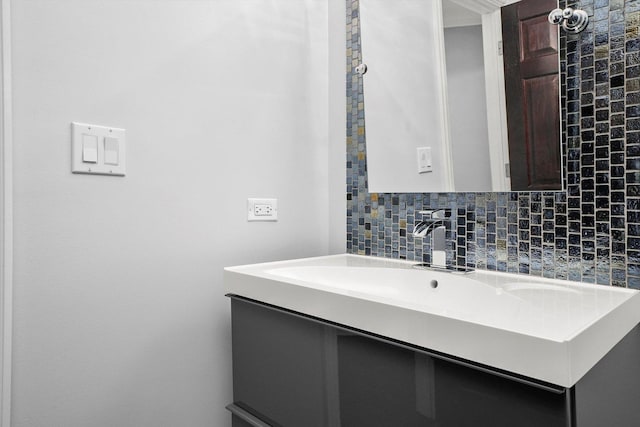 bathroom featuring vanity and decorative backsplash