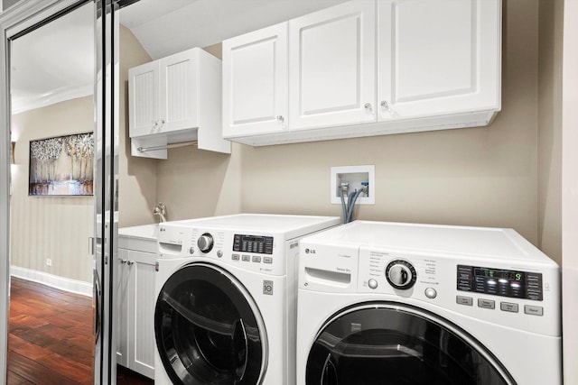 washroom with cabinets, wood-type flooring, and washer and dryer