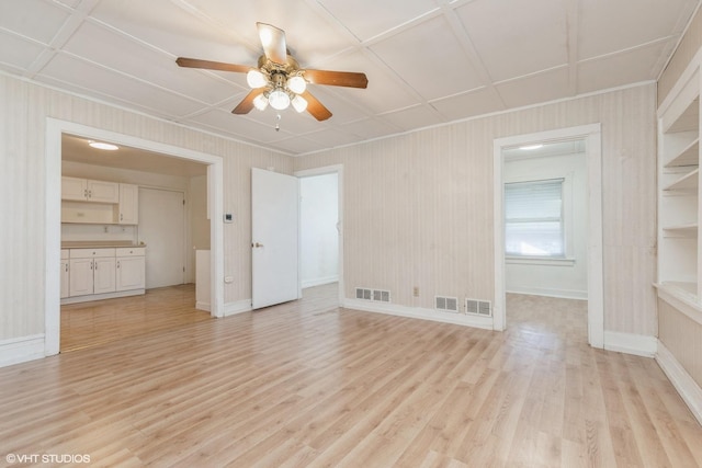 unfurnished room with ceiling fan and light hardwood / wood-style floors