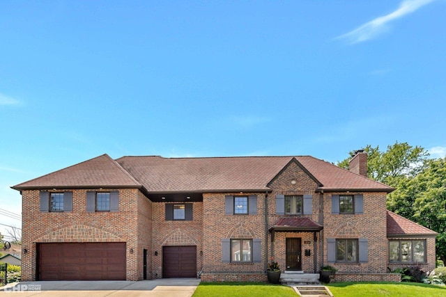 view of front of house with a garage and a front yard