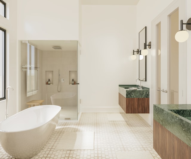 bathroom featuring vanity, a shower with shower door, and tile patterned flooring