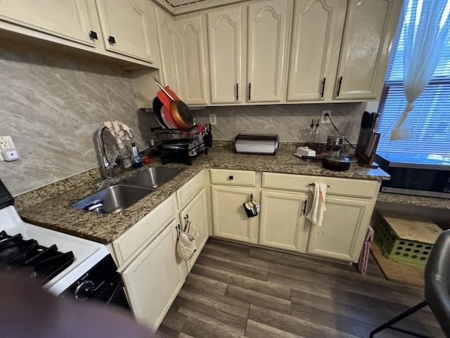 kitchen with sink, dark hardwood / wood-style flooring, and cream cabinetry