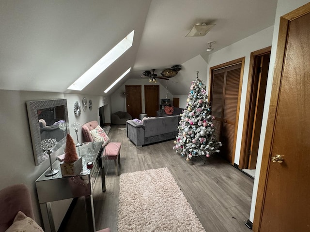 bonus room featuring light hardwood / wood-style flooring and lofted ceiling with skylight