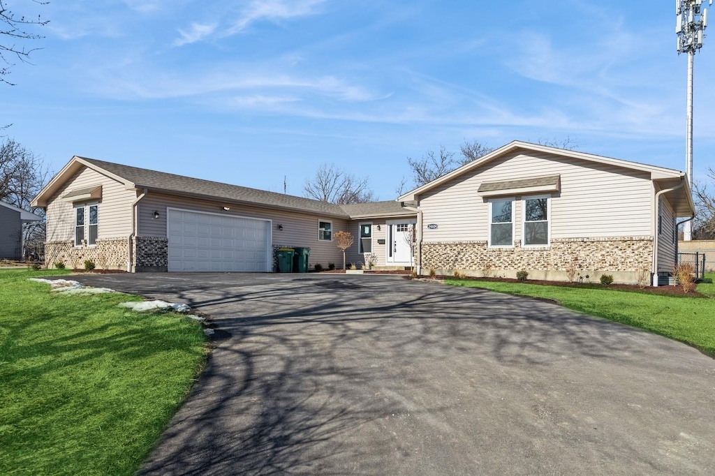 single story home with a garage and a front yard
