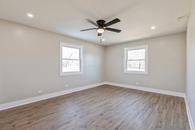 empty room featuring ceiling fan and light hardwood / wood-style flooring