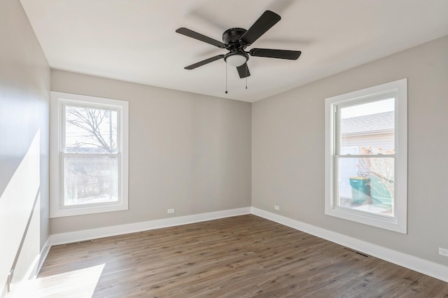 spare room featuring ceiling fan and dark hardwood / wood-style floors