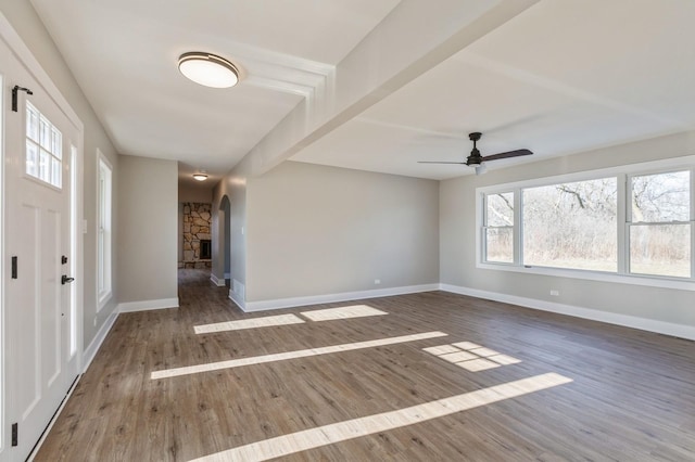 foyer entrance with beam ceiling, ceiling fan, and dark hardwood / wood-style flooring