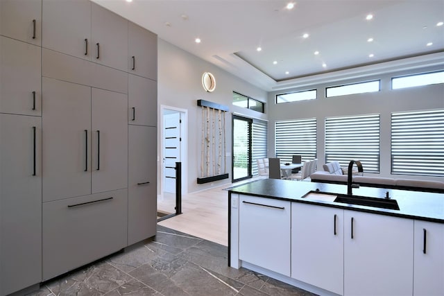 kitchen featuring sink and white cabinets