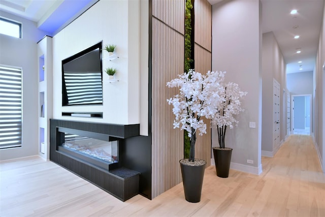 corridor with light hardwood / wood-style flooring