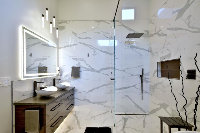 bathroom featuring tiled shower and vanity