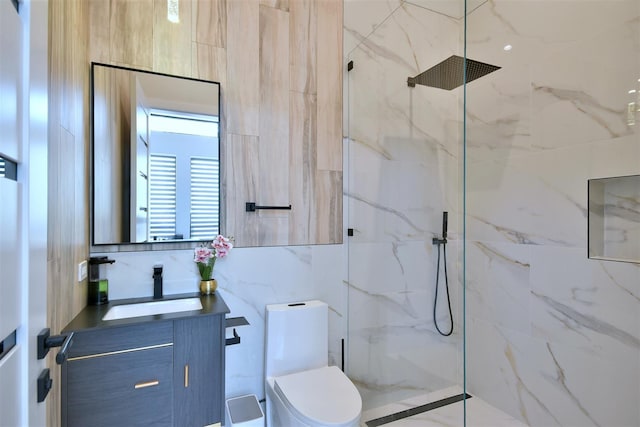 bathroom featuring an enclosed shower, vanity, and toilet