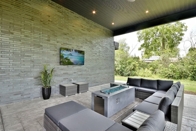 view of patio featuring an outdoor living space with a fire pit