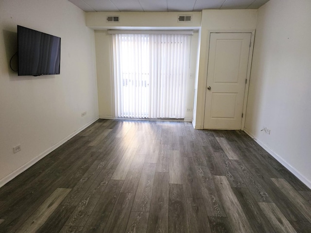 spare room featuring dark hardwood / wood-style floors