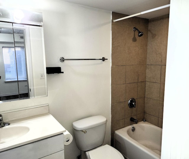 full bathroom with vanity, toilet, and tiled shower / bath combo