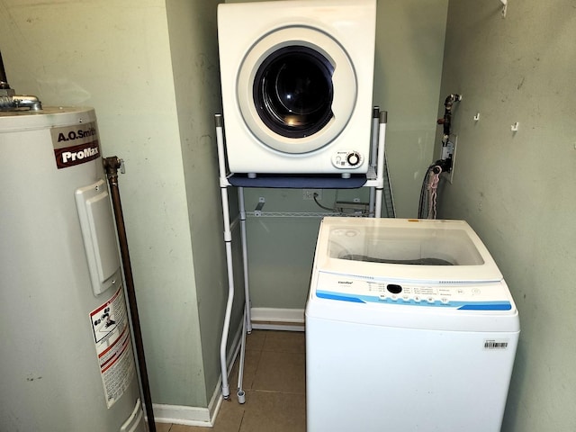 laundry room featuring water heater, stacked washer and dryer, and tile patterned floors