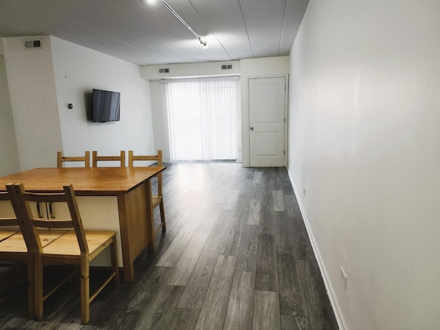 dining space featuring dark hardwood / wood-style floors