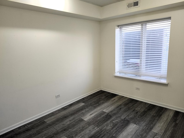 empty room featuring dark hardwood / wood-style flooring