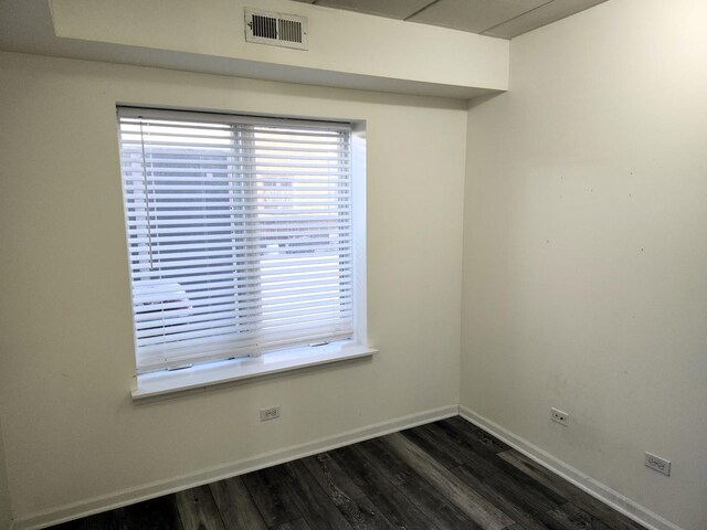 empty room featuring dark wood-type flooring