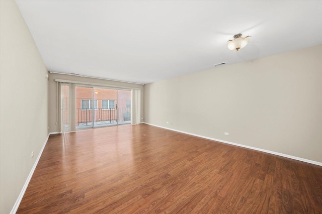 spare room featuring wood-type flooring