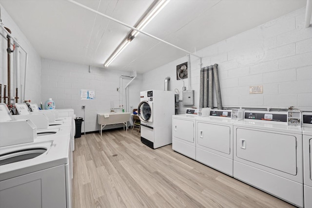 laundry room featuring sink, light hardwood / wood-style floors, and washer and dryer