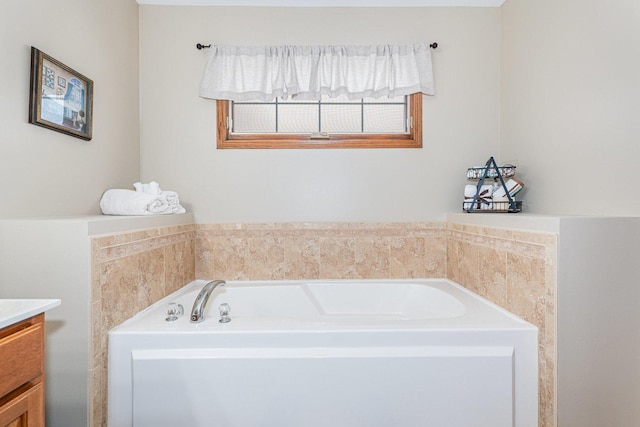 bathroom with a washtub and vanity