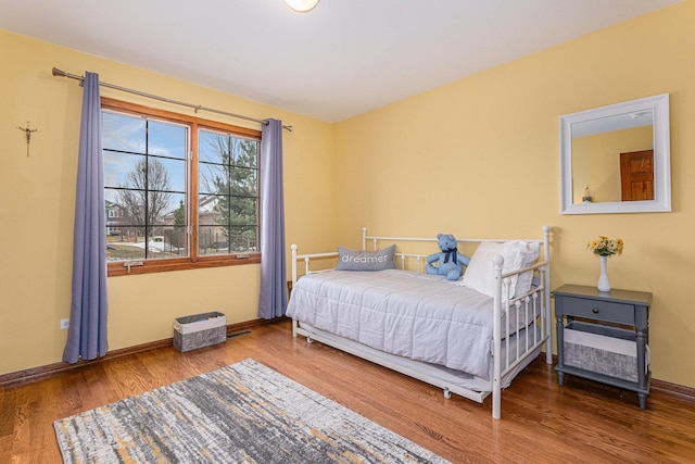 bedroom with hardwood / wood-style floors