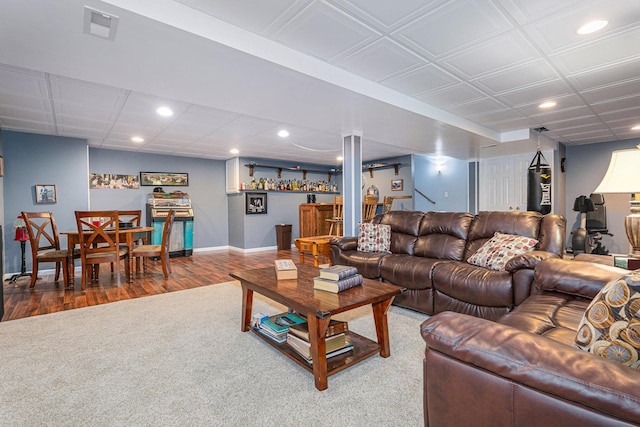 living room with bar area and carpet floors