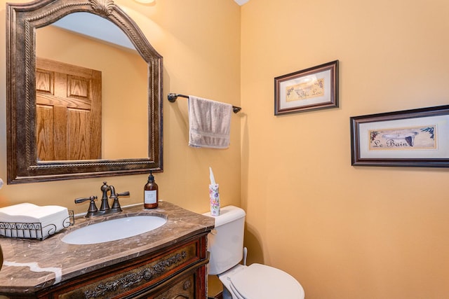 bathroom featuring toilet and vanity