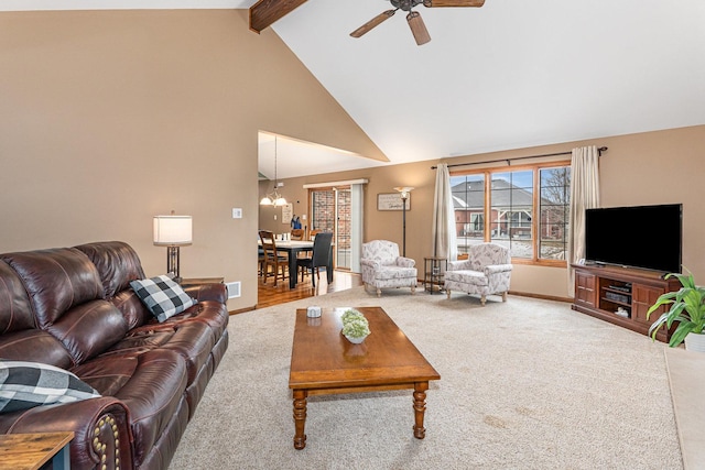 living room featuring ceiling fan with notable chandelier, beam ceiling, high vaulted ceiling, and carpet