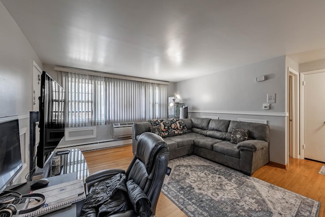 living room featuring wood-type flooring and baseboard heating