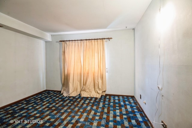 empty room with dark carpet