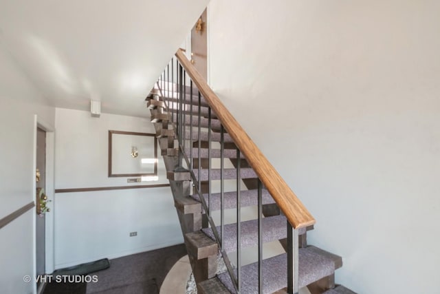 stairs featuring carpet flooring