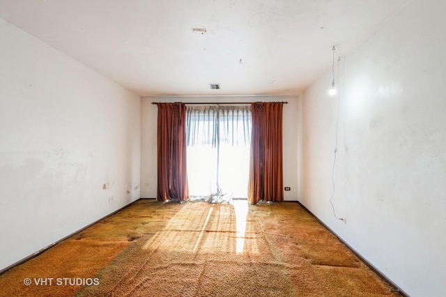 empty room with light colored carpet